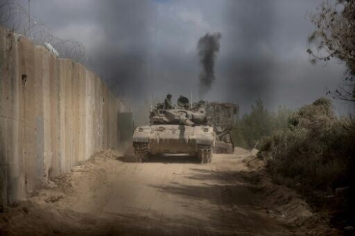 An Israeli battle tank is seen entering Lebanon from northern Israel at the southern Lebanese border point of Naqoura