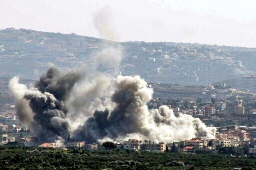 Seen from Lebanon's southern city of Tyre, smoke billows after an Israeli air strike on the village of Deir Qanoun