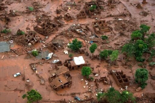 (FILES) Aerial view taken on on November 6, 2015, shows the covered in mud village of Bento Rodrigues, in Mariana, the southeastern Brazilian state of Minas Gerais, following the burst of a dam, at a mining waste site, of the company Samarco, jointly ow...