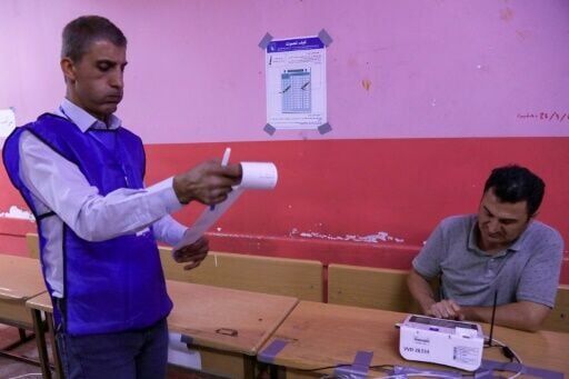 Electoral commission workers count votes at the end of the parliamentary election in Iraq's autonomous Kurdistan region
